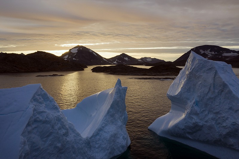 Large Icebergs float as the sun rises near Kulusuk, Greenland, on Aug. 16. Greenland has been melting faster in the last decade, and this summer, it has seen two of the biggest melts on record since 2012.