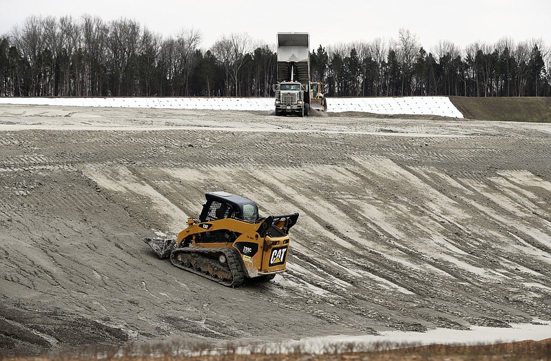 FILE - In this Jan. 25, 2017 file photo, heavy equipment is used at an ash storage site at Gallatin Fossil Plant in Gallatin, Tenn. Fallout from the Tennessee Valley Authority's handling of a massive 2008 coal ash spill at the Kingston Fossil Plant in Kingston, Tenn., keeps growing. CEO Jeff Lyash recognizes that TVA needs to win the public's trust. That's why the utility has been holding a series of community meetings to explain its plans for coal ash storage and let the public ask questions. TVA is also creating community action groups for interested citizens to act as liaisons between the public and the utility. (AP Photo/Mark Humphrey, File)