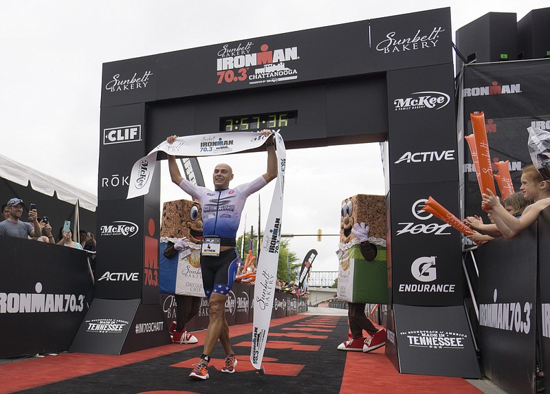 Matthew Russell makes his way through the chute to win the 2017 Sunbelt Bakery IRONMAN 70.3 Chattanooga triathlon presented by McKee A Family Bakery in downtown Chattanooga on Sunday, May 21, 2017. Photo by Dan Henry | DanHenryPhotography.com