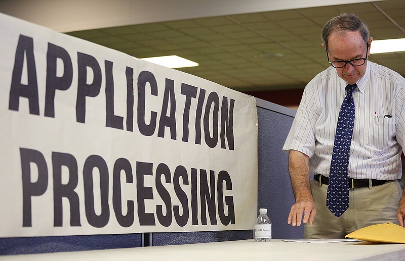 Robert Hensley gets his paperwork organized during a job fair put on by EPIC Talent Solutions Wednesday, August 22, 2018 at the Chattanooga Times Free Press in Chattanooga, Tennessee. There were 49 companies with job openings on hand to speak with job seekers. 