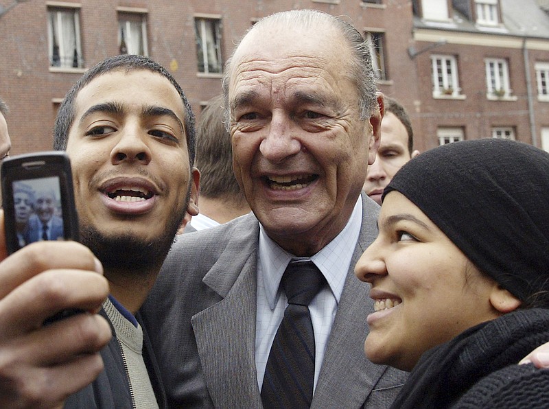 FILE - In this Nov.14, 2006 file photo, French President Jacques Chirac poses with residents during his visit to Amiens, northern France. Former French President Jacques Chirac has died at 86. (AP Photo/Michel Spingler, File)