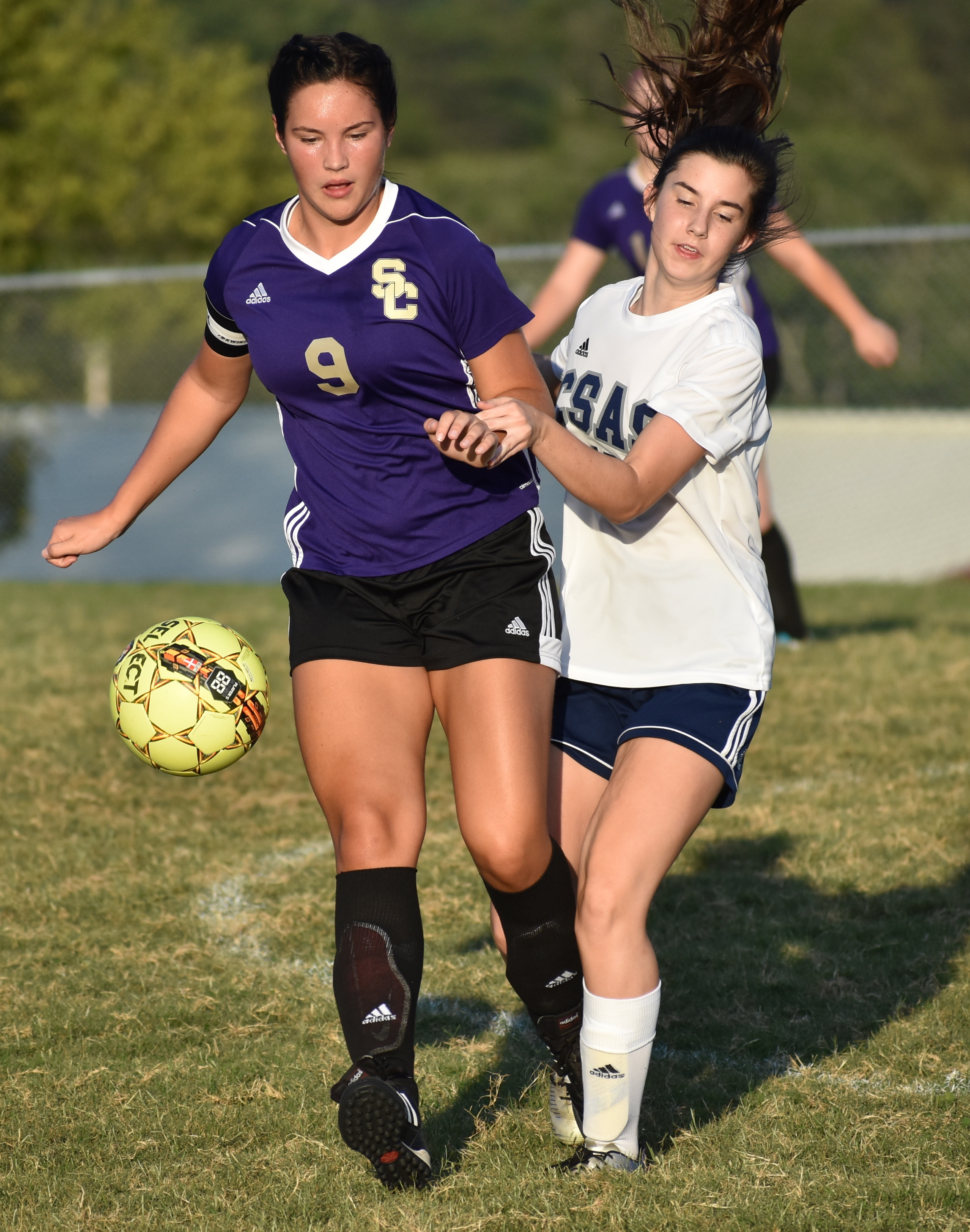 Staff photo by Patrick MacCoon / Sequatchie County junior Abbi Cartwright, left, battles for possession at midfield during Thursday's home game against CSAS.