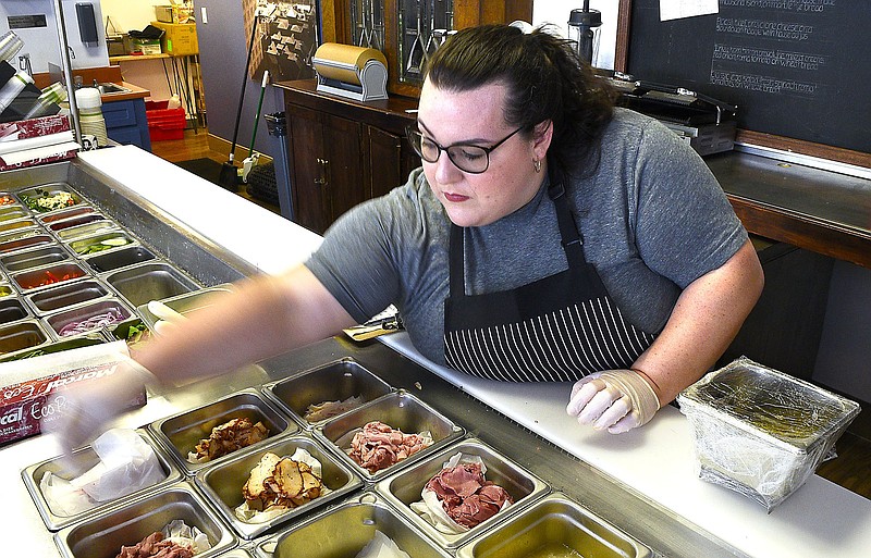 Staff Photo by Robin Rudd/  Anastasia Burton arranges items on the making tray.  Anastasia's Old World Delicatessen located at the corner of Martin Luther King Jr. Blvd and Chestnut Street will open on Monday.  The eatery was photographed on September 27, 2019.