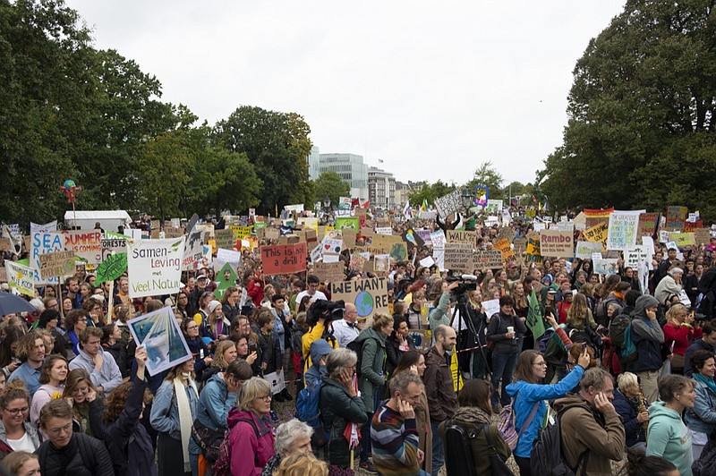 Thousands marched as part of a second wave of worldwide protests demanding action on climate change in The Hague, Netherlands, Friday, Sept. 27, 2019. (AP Photo/Mike Corder)