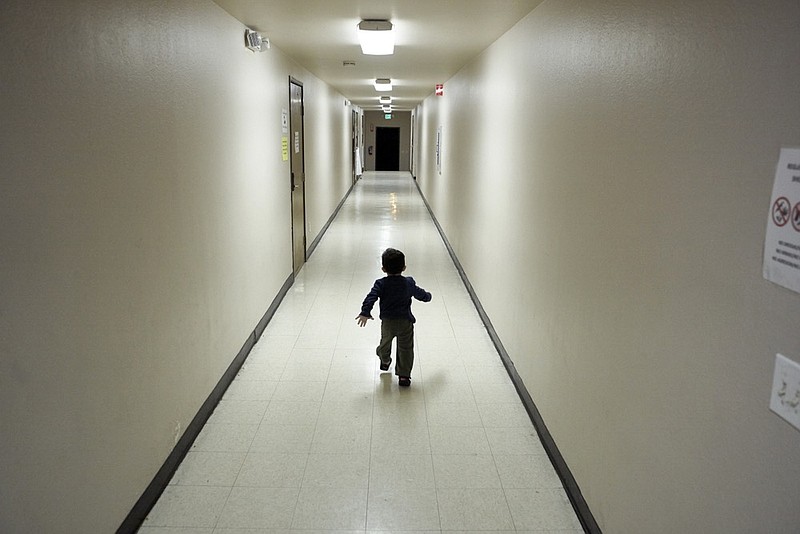 FILE - In this Dec. 11, 2018 file photo, an asylum-seeking boy from Central America runs down a hallway after arriving from an immigration detention center to a shelter in San Diego. The Trump administration will make a case in court to end a longstanding settlement governing detention conditions for immigrant children, including how long they can be held by the government. A hearing is scheduled before a federal judge Friday, Sept. 27, 2019, in Los Angeles over the so-called Flores settlement. (AP Photo/Gregory Bull, File)


