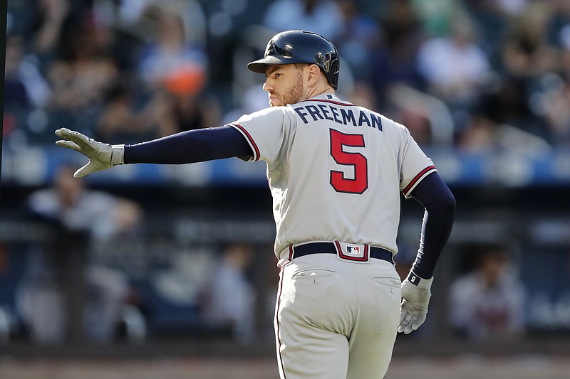 Associated Press photo by Kathy Willens / Atlanta Braves first baseman Freddie Freeman waves toward the New York Mets' dugout after he was replaced by a pinch-runner after he hit a single during the third inning of Sunday's game in New York.