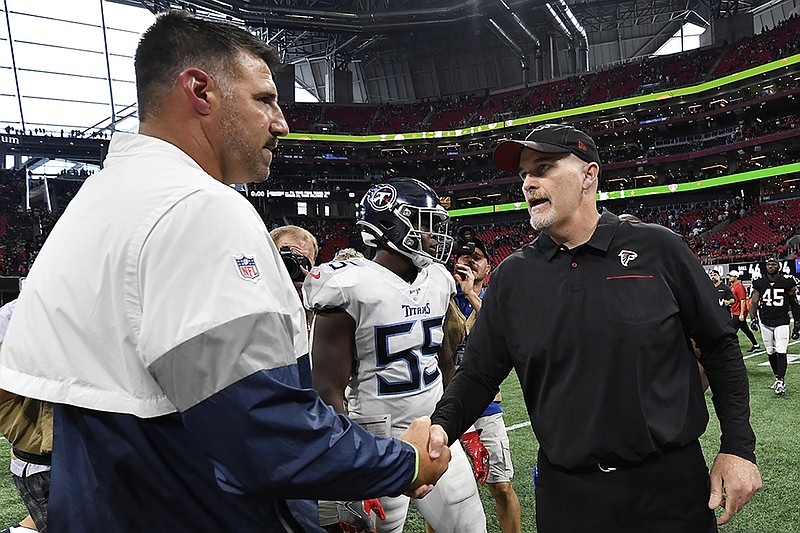 Associated Press photo by John Amis / Atlanta Falcons coach Dan Quinn, right, speaks with Tennessee Titans counterpart Mike Vrabel after Sunday's game at Mercedes-Benz Stadium. The visiting Titans won 24-10.