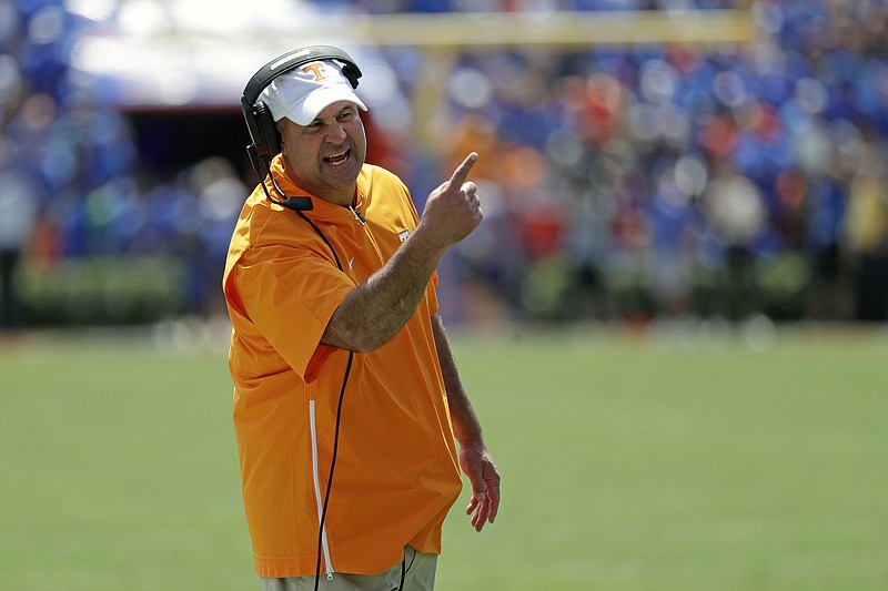 Tennessee head coach Jeremy Pruitt has words with an official during the first half of an NCAA college football game against Florida, Saturday, Sept. 21, 2019, in Gainesville, Fla. (AP Photo/John Raoux)