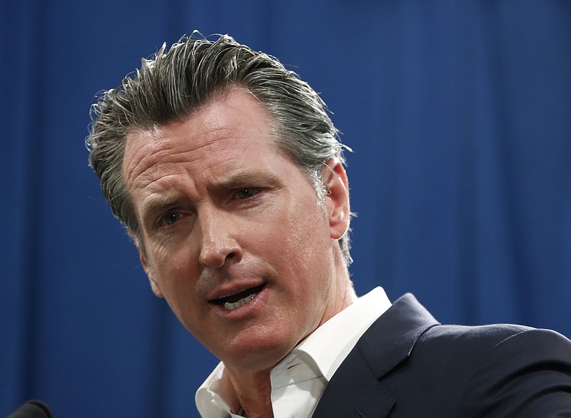 In this Sept. 16, 2019, file photo, Gov. Gavin Newsom answers a question during a news conference in Sacramento, Calif. Newsom announced Monday, Sept. 30, he signed a law that would let athletes at California universities make money from their images, names or likenesses. The law also bans schools from kicking athletes off the team if they get paid. (AP Photo/Rich Pedroncelli, File)