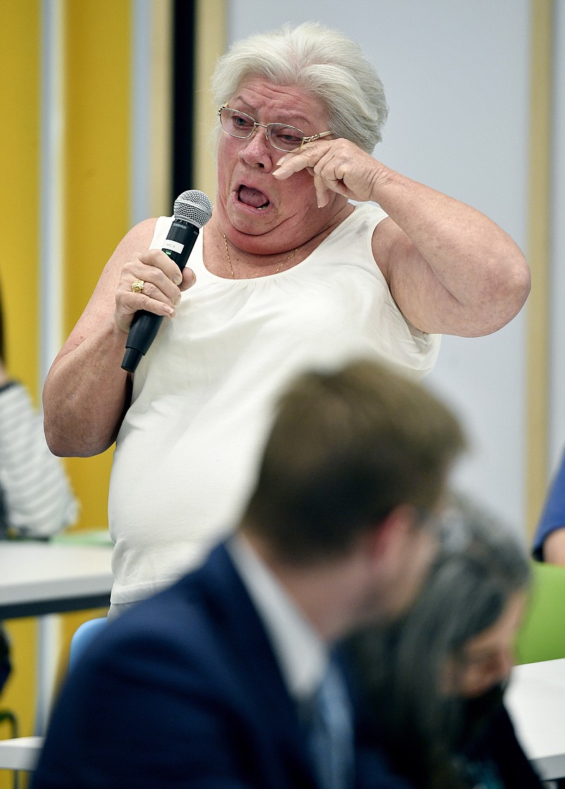 Mary Baggott cries as she tells about losing her TennCare insurance benefits because of a mistake with the mailed application during a public hearing Tuesday, Oct. 1, 2019, in Nashville, Tenn. Tennessee held its first public hearing on its push to become the first state in the nation to receive its Medicaid funding in a lump sum under a proposal seeking to drastically overhaul the program that provides health care services to low-income and disabled residents. (Larry McCormack,/The Tennessean via AP)