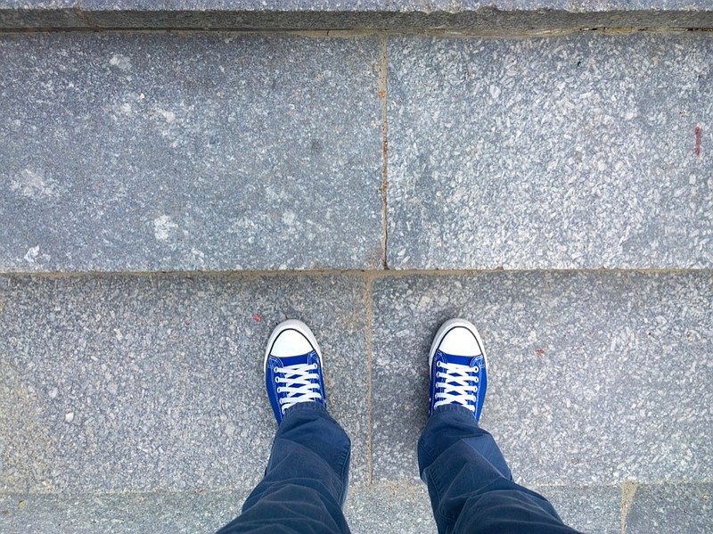 Feet on the stairs. feet walk walking tile sidewalk / Getty Images
