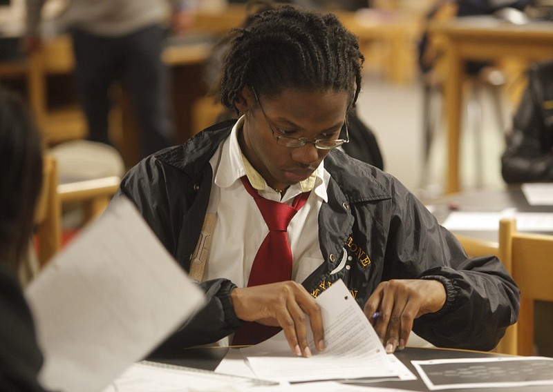 Staff photo by Jake Daniels/Chattanooga Times Free Press -- Nov 15, 2011
Clayton Mason {CQ}, 17, leafs through his guidebook during the Launch program Tuesday. Students at Howard High School participated in Launch, a program aimed at increasing knowledge of entrepreneurship in youths, on Tuesday afternoon.