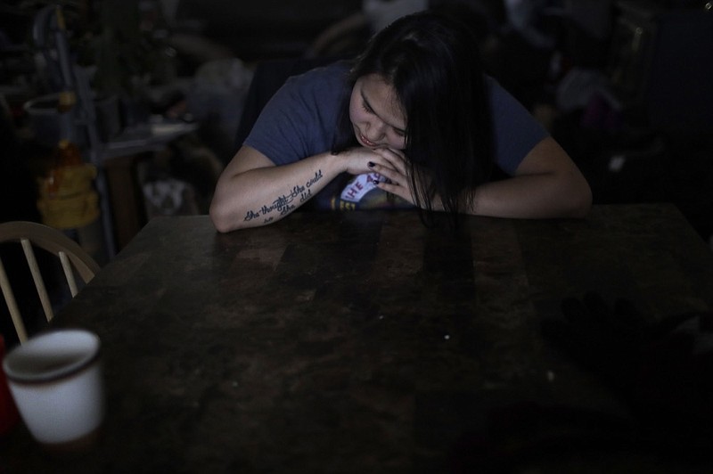In this Feb. 16, 2019, photo, Deidre Levi rests her head for a moment in her grandmother's house before a basketball game in the Native Village of St. Michael, Alaska. Levi says she spoke up about her sexual assault because she wanted to be a role model for girls in Alaska. (AP Photo/Wong Maye-E)