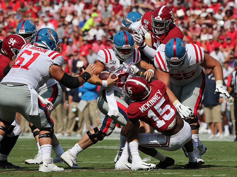 Alabama photo by Kent Gidley / Alabama safety Xavier McKinney (15) and outside linebacker Anfernee Jennings (33) struggled at times last Saturday to contain Ole Miss freshman quarterback John Rhys Plumlee, who rushed 25 times for 109 yards in the Crimson Tide's 59-31 win.