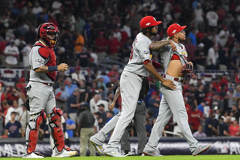 AP photo by John Amis / St. Louis Cardinals relief pitcher Carlos Martinez, right, celebrates with teammates after Game 1 of a best-of-five National League Division Series against the Atlanta Braves on Thursday in Atlanta. The Cardinals won 7-6.