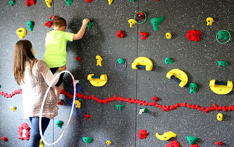 Contributed photo / Amanda Cutting, occupational therapist at the Siskin Center for Developmental Pediatrics, works with a child on the newly installed therapy wall.