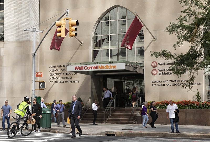 In this Sept. 26, 2019, photo, people pass the Weill Cornell Medicine center in New York. (AP Photo/Mark Lennihan)


