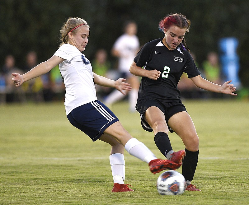 Staff Photo by Robin Rudd / Arts & Science's Gracie Fogo, left, and East Hamilton's Mia Moore battle for the ball during a soccer match Thursday night at East Hamilton. 