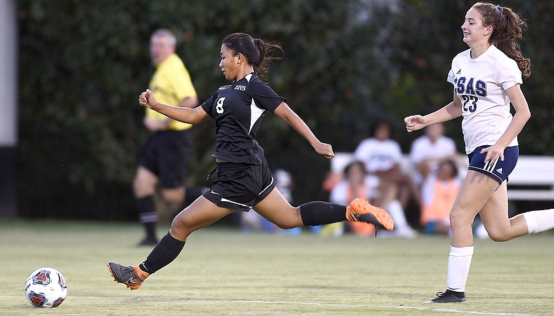 Staff Photo by Robin Rudd/  East Hamilton's Tenley Yates (8) gets past CSAS's Audrey Conley (23) for a shot on goal.  Her shot was blocked by Yates scored on the rebound.  The CSAS Lady Patriots visited the East Hamilton Lady Hurricanes in TSSAA soccer on October 3, 2019.