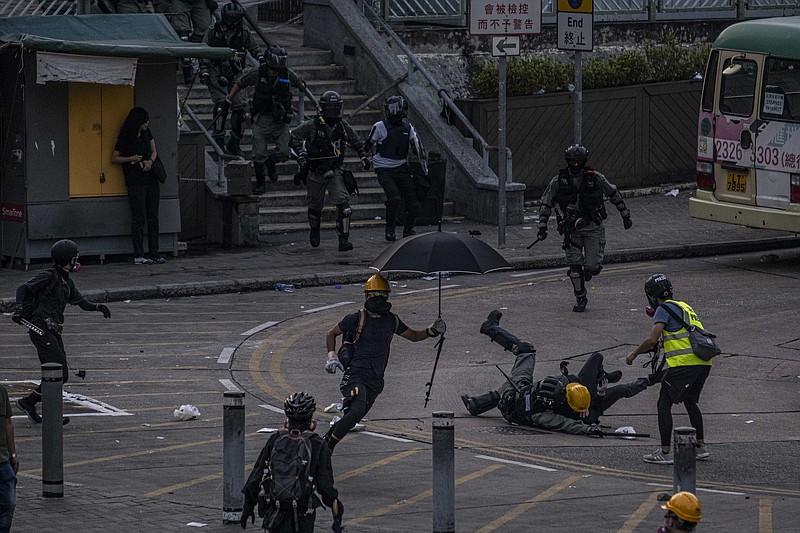 Photo by Lam Yik Fei of The New York Times/Riot police officers clash with protestors near the Wong Tai Sin transit station in Hong Kong last Tuesday. Clashes reached their most intense point in four months of protests on the same day that Beijing celebrated 70 years of Communist Party rule.