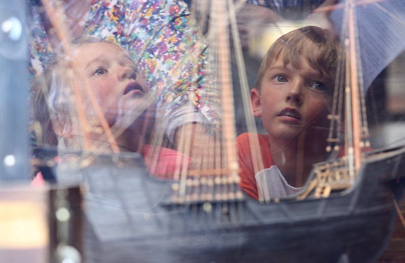 Staff photo by Erin O. Smith / Ada Maclellan and Liam Maclellan, 8, look at a much smaller replica of one of Christopher Columbus' ships at Ross's Landing Friday, October 4, 2019 in Chattanooga, Tennessee. Larger replicas of Christopher Columbus' ships, with the exception of Santa Maria, are on display in Chattanooga this month.