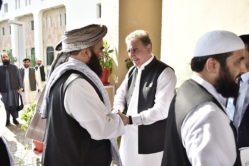 In this photo released by the Foreign Office, Pakistan's Foreign Minister Shah Mehmood Qureshi, center, receives members of Taliban delegation at the Foreign Office in Islamabad, Pakistan, Thursday, Oct. 3, 2019. (Pakistan Foreign Office via AP)


