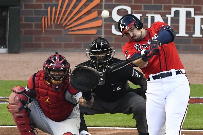 AP photo by Scott Cunningham / Atlanta Braves left fielder Adam Duvall watches his two-run homer against the St. Louis Cardinals in the seventh inning of Game 2 of the team's NL Division Series on Friday in Atlanta. Duvall was pinch-hitting for starting pitcher Mike Foltynewicz.