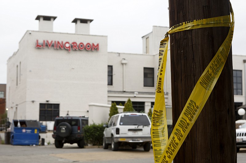 Staff photo by C.B. Schmelter / Crime scene tape is seen hanging off a pole, along 14th Street, in front of the Living Room at Coyote Jack's nightclub on Sunday, Oct. 6, 2019 in Chattanooga, Tenn. A fatal shooting happened at the location early Sunday morning.
