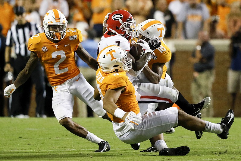 Staff photo by C.B. Schmelter / Georgia running back D'Andre Swift is tackled by Tennessee defensive back Nigel Warrior (18) and linebacker Henry To'o To'o (11) at Neyland Stadium on Oct. 5.