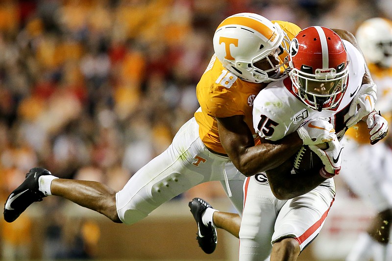 Staff photo by C.B. Schmelter / Tennessee senior safety Nigel Warrior brings down Georgia wide receiver Lawrence Cager during Saturday night's game at Neyland Stadium.