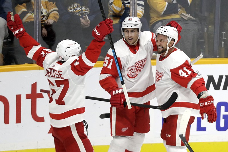 AP photo by Mark Humphrey / Detroit Red Wings center Luke Glendening,right, celebrates with Valtteri Filppula, center, and Taro Hirose after scoring against the Nashville Predators during the third period of Saturday night's game in Nashville.