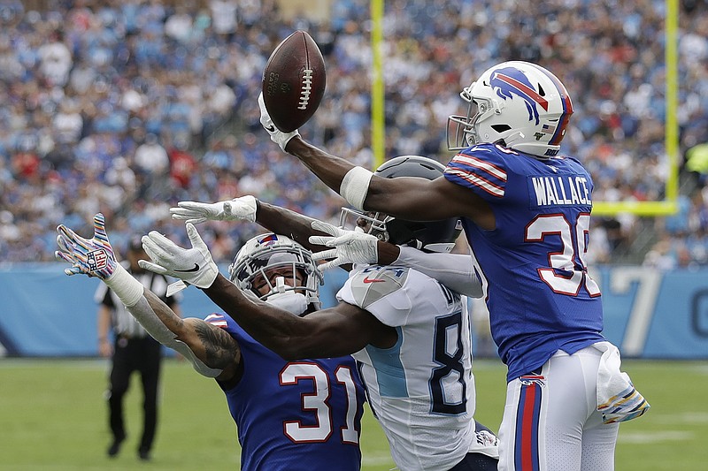 AP photo by James Kenney / Buffalo Bills defensive backs Levi Wallace, right, and Dean Marlowe, left, break up a pass intended for Tennessee Titans wide receiver Corey Davis during the first half of Sunday's game in Nashville. Tennessee lost 14-7.