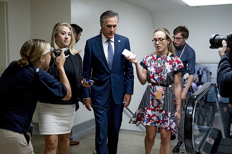 File photo by Anna Moneymaker of The New York Times/Sen. Mitt Romney, R-Utah, talks with reporters on his way to the Senate floor on Capitol Hill on Aug. 1. With most Republicans rushing to defend President Trump against impeachment push, a "deeply troubled" Romney stands apart.