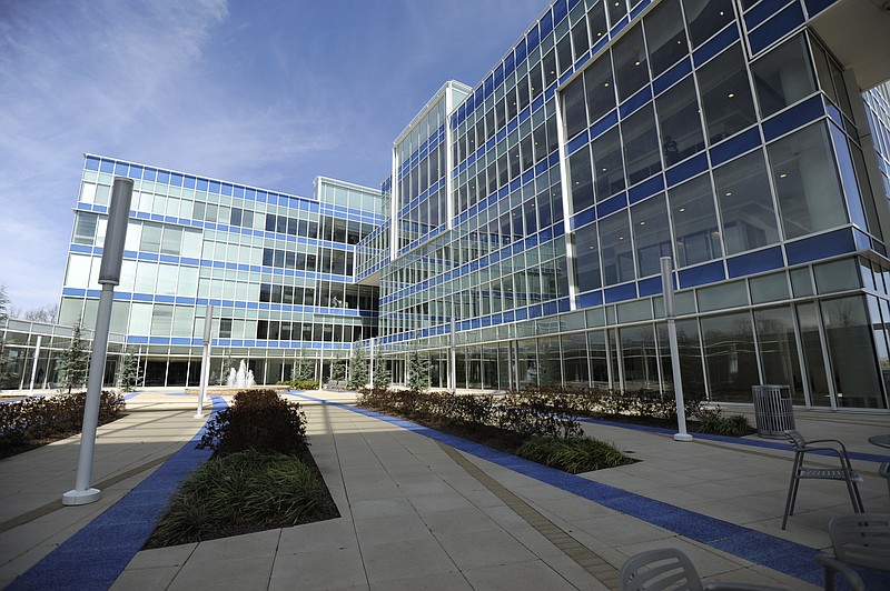 Staff file photo /  The BlueCross BlueShield of Tennessee campus in downtown Chattanooga is environmentally designed with glass windows that allow sunlight to warm the building, cutting down on heating costs. In the center of the building is a courtyard with tables and a fountain. Gardens and walking trails are also scattered throughout the campus.
