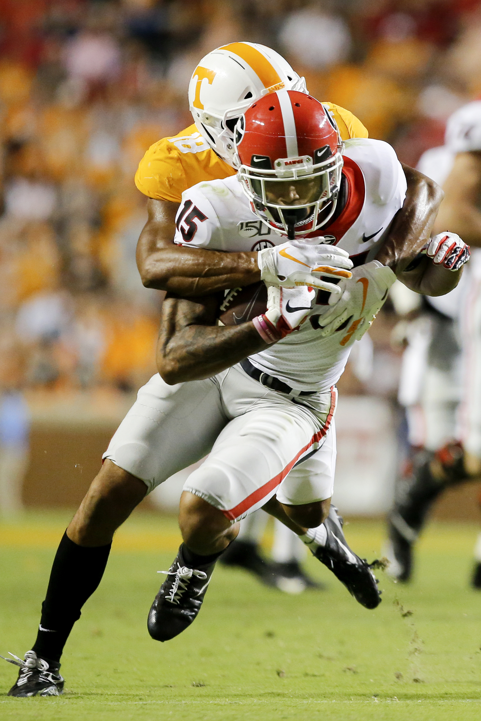 Staff photo by C.B. Schmelter / Tennessee defensive back Nigel Warrior (18) brings down Georgia wide receiver Lawrence Cager (15) at Neyland Stadium on Saturday, Oct. 5, 2019 in Knoxville, Tenn.