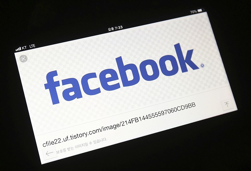 This Wednesday, March 21, 2018, file photo shows the Facebook logo on a smartphone in Ilsan, South Korea. Facebook has agreed to pay $40 million to advertisers who said it inflated the amount of time its users watched videos. (AP Photo/Ahn Young-joon, File)