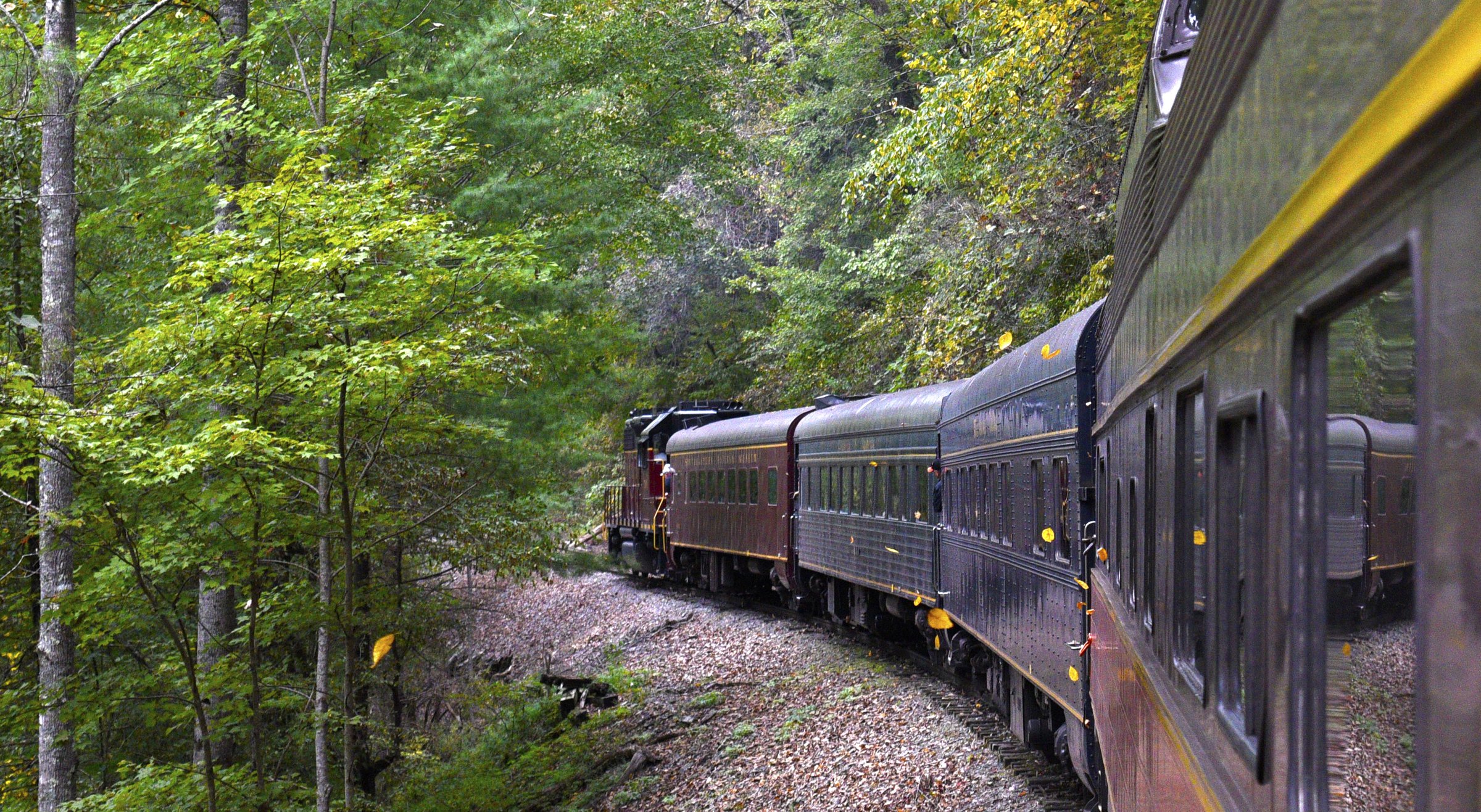 Staff Photo by Robin Rudd/ Some of the first leaves of Fall fly past the train as it makes it's way along the Hiwassee River. The Tennessee Valley Railroad Museum's