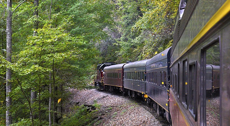 Staff Photo by Robin Rudd/  Some of the first leaves of Fall fly past the train as it makes it's way along the Hiwassee River.  The Tennessee Valley Railroad Museum's "Hiwassee Loop" excursion travels from near Etowah along the Hiwassee River to Farner, Tennessee.  The 50 mile, 3 1/2 hours journey occurred on October 6, 2019.  The Museum will continues the rides on select days until November 24.  