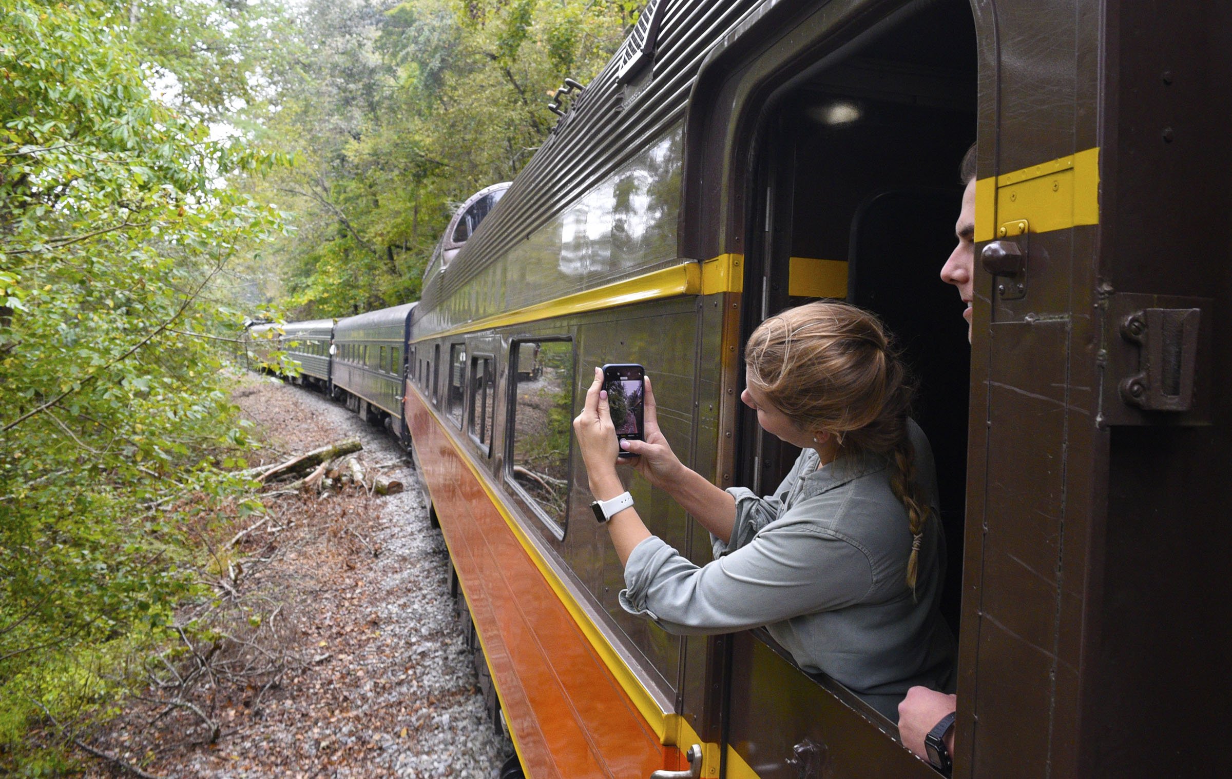 Staff Photo by Robin Rudd/ A passenger films the trip with her phone from one of the car's vestibules.