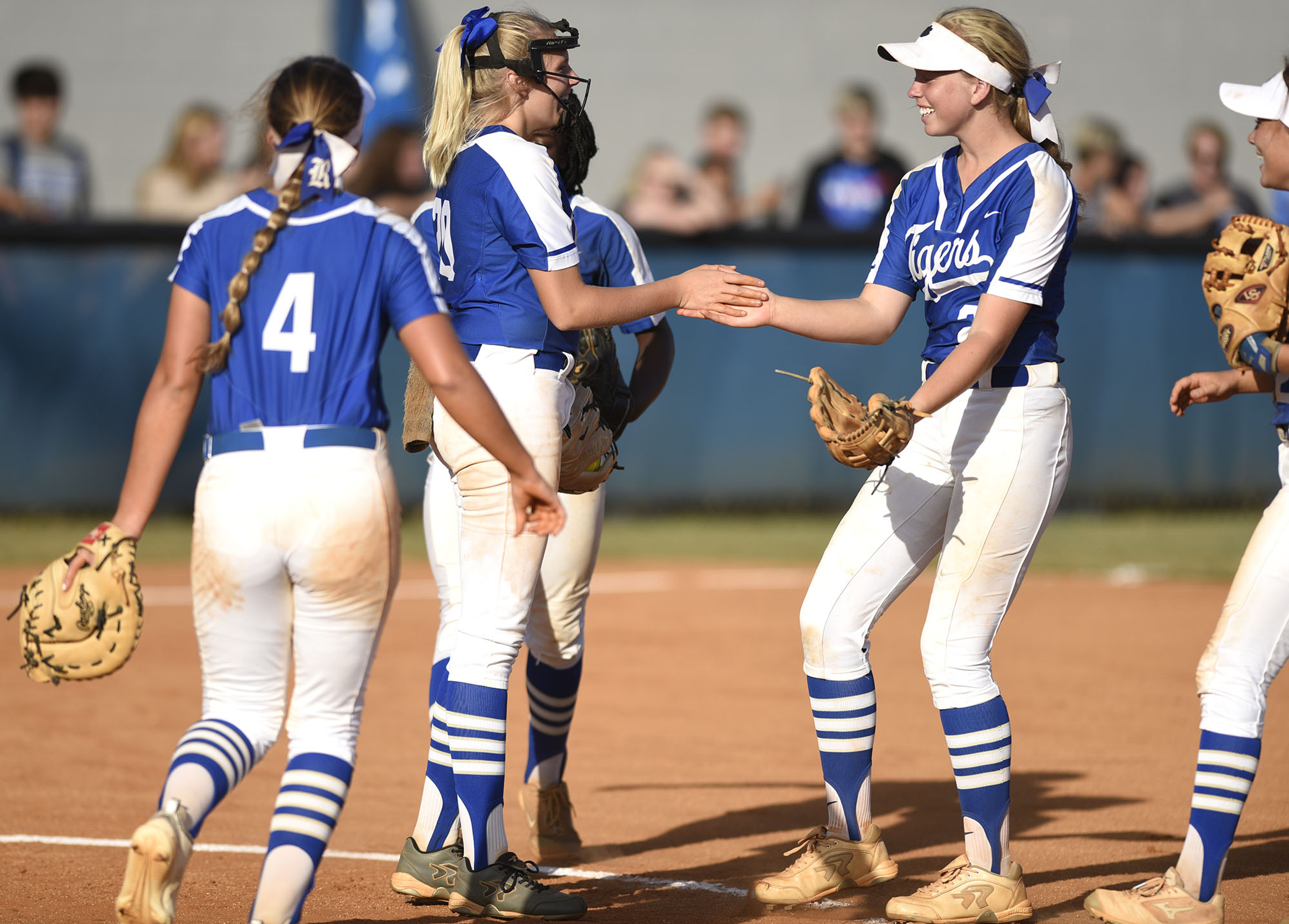 Staff Photo by Robin Rudd / Ringgold shortstop Riley Nayadley, right, and other Lady Tigers infielders congratulate pitcher Kaylee Phillips, center, after she caught a sharp line drive during a GHSA Class AAA state playoff game Wednesday in Ringgold, Ga.