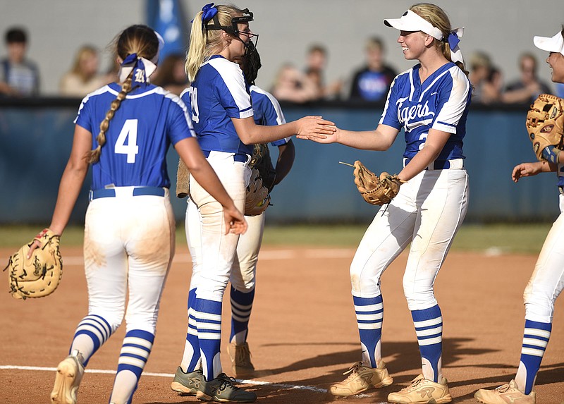 Staff Photo by Robin Rudd / Ringgold shortstop Riley Nayadley, right, and other Lady Tigers infielders congratulate pitcher Kaylee Phillips, center, after she caught a sharp line drive during a GHSA Class AAA state playoff game Wednesday in Ringgold, Ga.