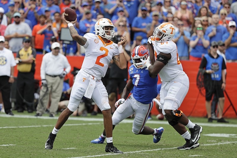 AP photo by John Raoux / Tennessee quarterback Jarrett Guarantano throws a pass as offensive lineman Wanya Morris, right, tries to block Florida linebacker Jeremiah Moon during the teams' SEC East matchup Sept. 21 in Gainesville, Fla.