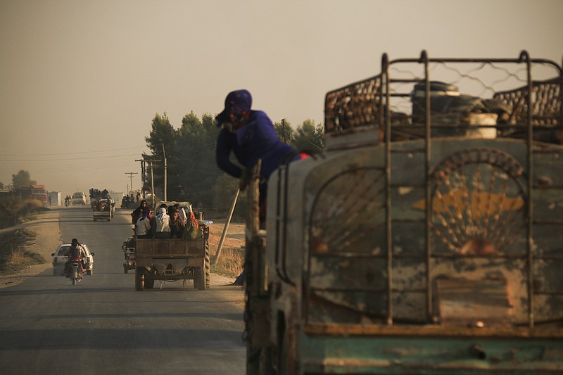 Syrians flee shelling by Turkish forces in Ras al Ayn, northeast Syria, Wednesday, Oct. 9, 2019. Turkish President Recep Tayyip Erdogan announced Wednesday the start of a Turkish military operation against Kurdish fighters in northeastern Syria. (AP Photo/Baderkhan Ahmad)