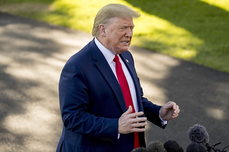 President Donald Trump speaks to members of the media on the South Lawn of the White House in Washington, Thursday, Oct. 10, 2019, before boarding Marine One for a short trip to Andrews Air Force Base, Md., and then on to Minneapolis, for a campaign rally.. (AP Photo/Andrew Harnik)