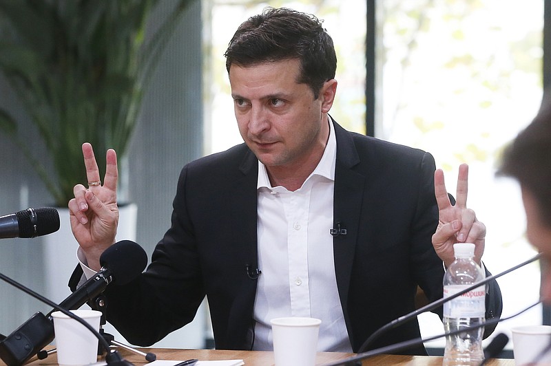 Ukrainian President Volodymyr Zelenskiy speaks during talks with journalists in Kyiv, Ukraine, Thursday, Oct. 10, 2019. Ukrainian President is holding an all-day “media marathon” in a Kyiv food court amid growing questions about his actions as president. (AP Photo/Efrem Lukatsky)