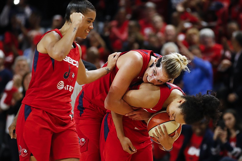 AP photo by Alex Brandon / Washington Mystics guard Natasha Cloud, left, forward Elena Delle Donne and guard Kristi Toliver celebrate during the second half of Game 5 of the WNBA Finals against the Connecticut Sun on Thursday night in Washington.