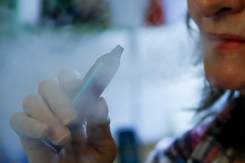 Associated Press file photo / A woman uses her vaping device in Harmony, Pa.