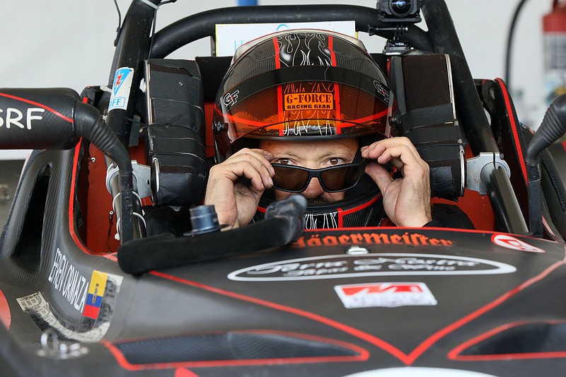 Staff photo by Erin O. Smith / Efren Ormaza puts on his sunglasses before racing in the Chattanooga MotorCar Festival time trials along Riverfront Parkway in Chattanooga, Tennessee. Ormaza was driving a 1982 Spec Racer Ford G2.