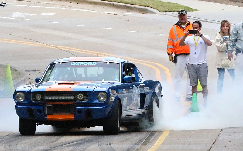 Staff photo by Erin O. Smith / Joe Palmer burns rubber as he takes off in a 1965 Shelby Mustang during the Chattanooga MotorCar Festival time trials along Riverfront Parkway in Chattanooga, Tennessee. 