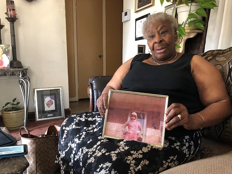 Minnie Hill holds a photo of her late daughter, Rosie Hill, as she speaks to a reporter in her home on Thursday, Oct. 10, 2019 in Memphis, Tenn. Rosie Hill was found dead in Florida in 1982. (AP Photo/Adrian Sainz)


